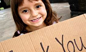 Girl holding thank you sign