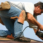 Man on roof with nail gun